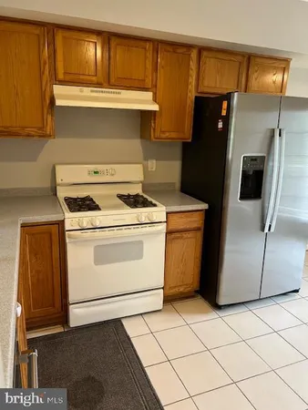 a white stove top oven sitting inside of a kitchen