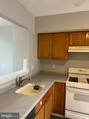 a kitchen with a sink stove and cabinets