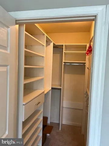 a room with walk in closet and a window