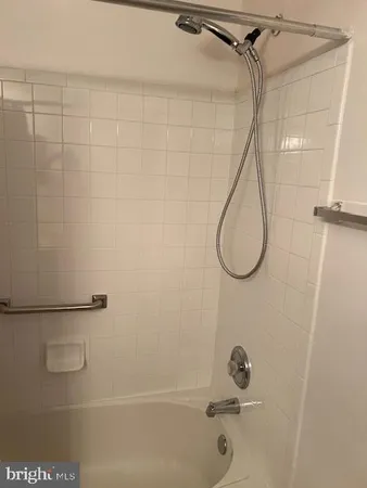 a bathroom with a bath tub with a shower