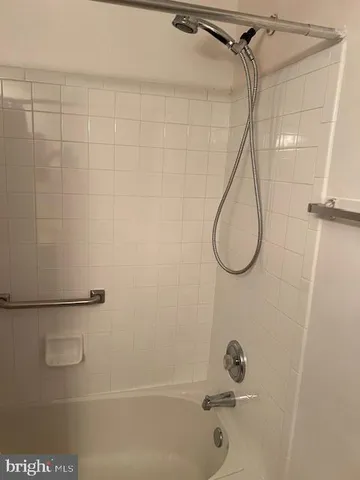 a bathroom with a bath tub with a shower