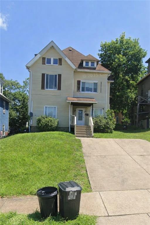 a front view of a house with a yard