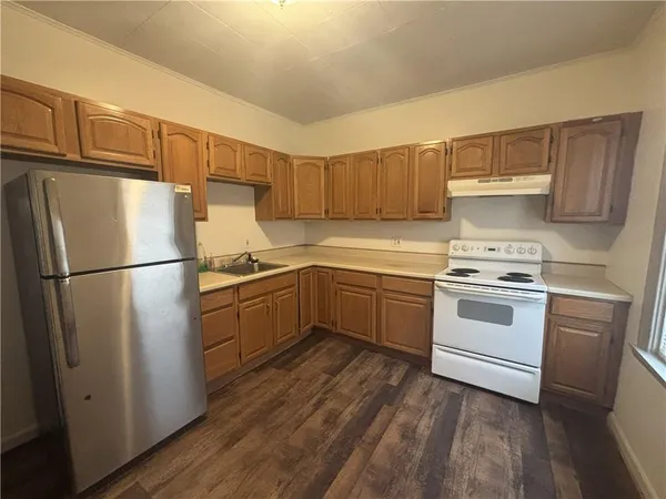 a kitchen with a white cabinets and white appliances