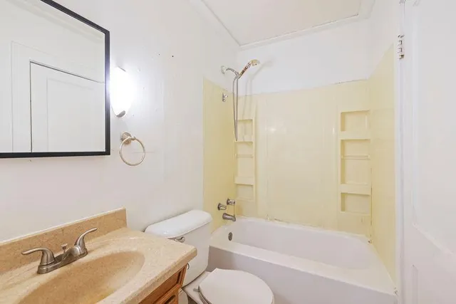 a bathroom with a sink toilet tub and shower