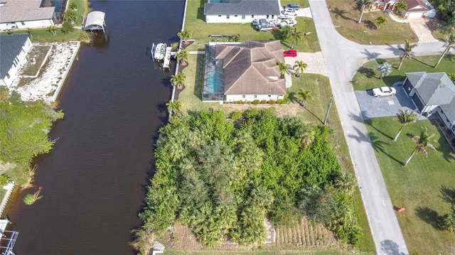 an aerial view of a house with a yard basket ball court and outdoor seating