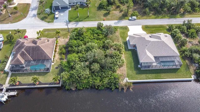 an aerial view of a house with a garden and swimming pool