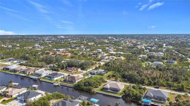 an aerial view of residential houses with outdoor space and parking