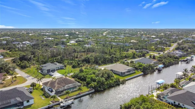 an aerial view of residential houses with outdoor space and swimming pool