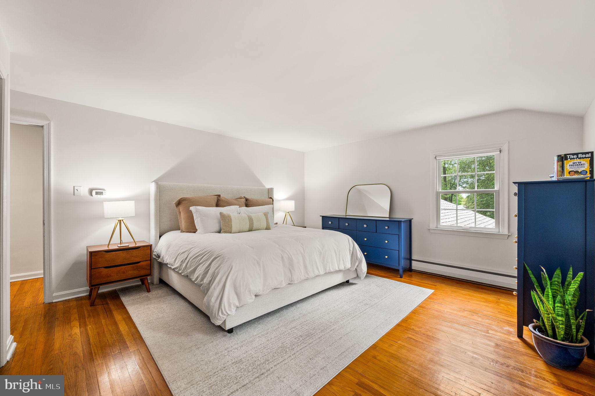 201 Morris Road Exton, PA 19341 - Photo 24 of 33 a bedroom with a bed lamp and a potted plant