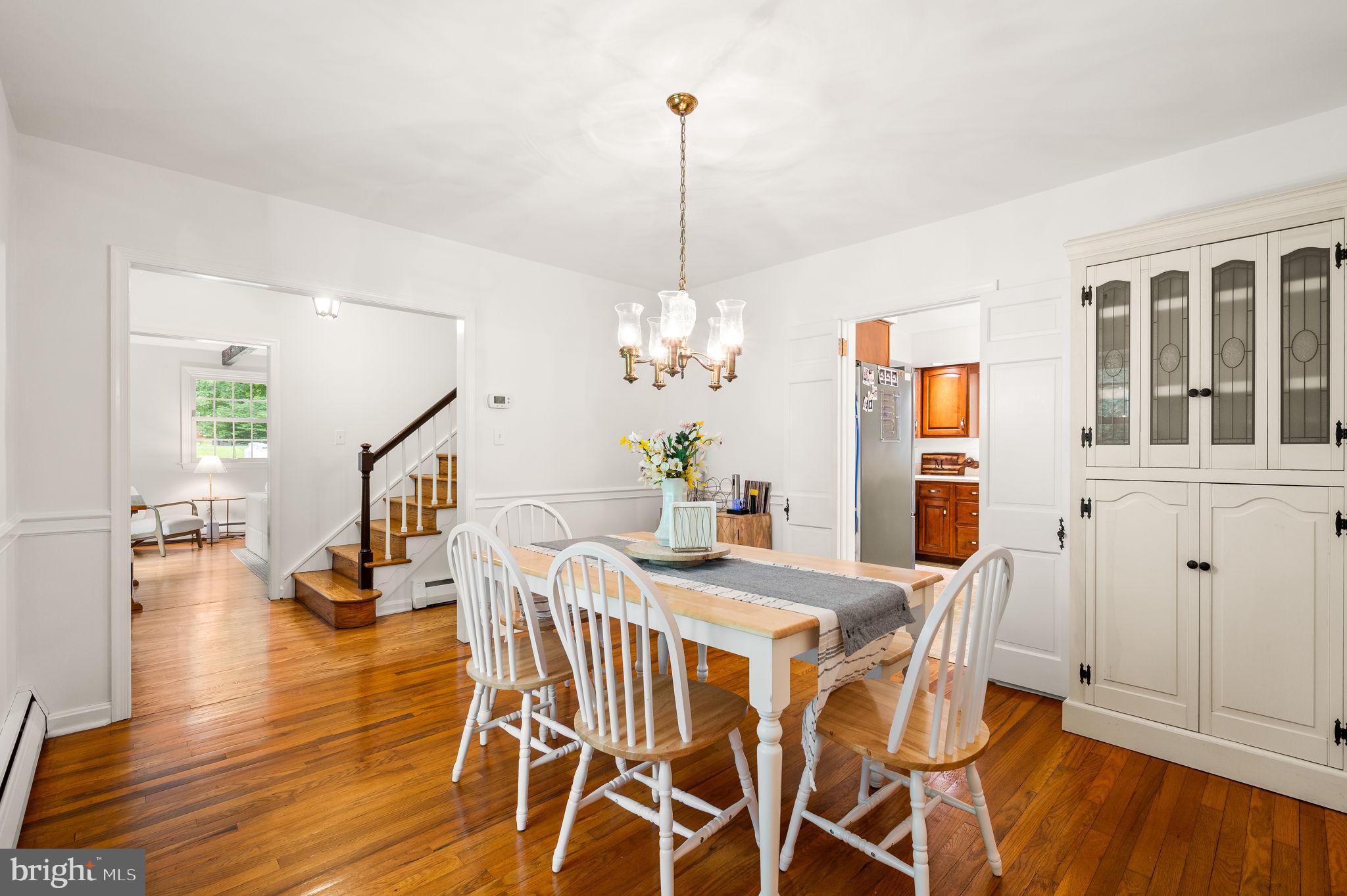 201 Morris Road Exton, PA 19341 - Photo 7 of 33 a view of a dining room with furniture wooden floor and a chandelier