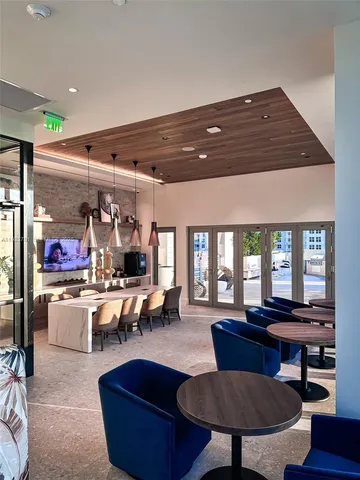 a living room with furniture and a kitchen view