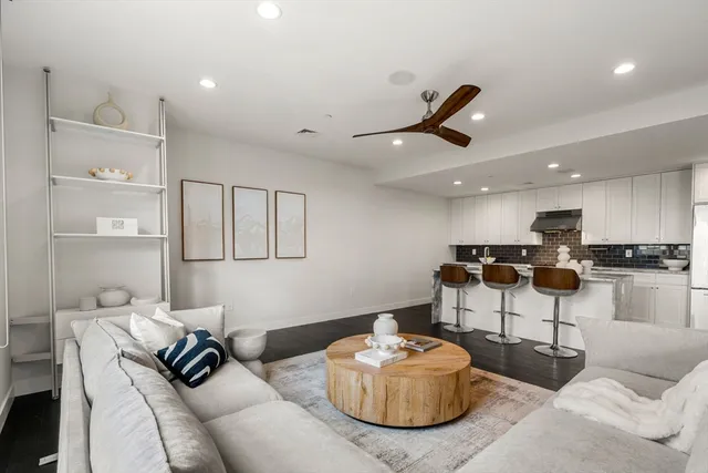 a living room with furniture and kitchen view