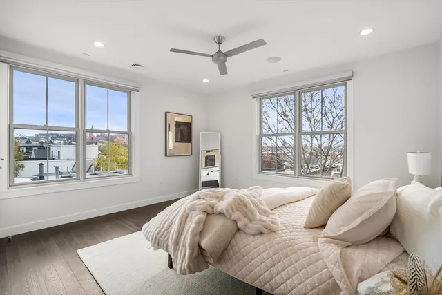 a bedroom with a large bed and a large window