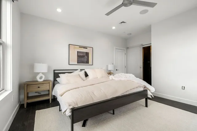 a bedroom with a bed and a night stand