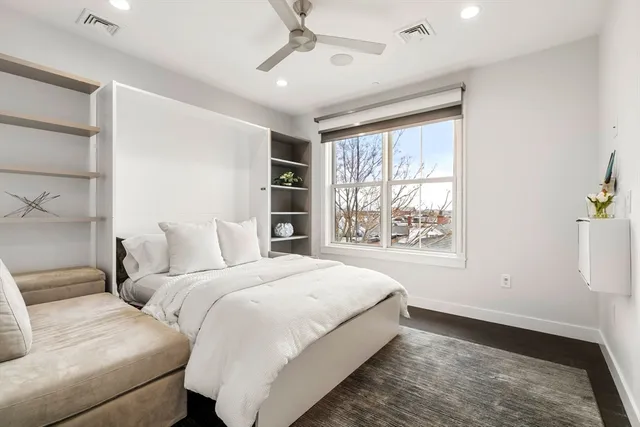 a bedroom with a large bed and a window