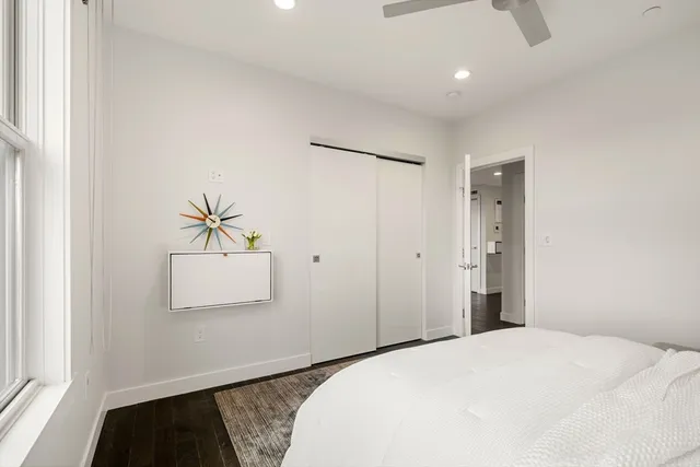 a bedroom with a bed and a painting on the wall