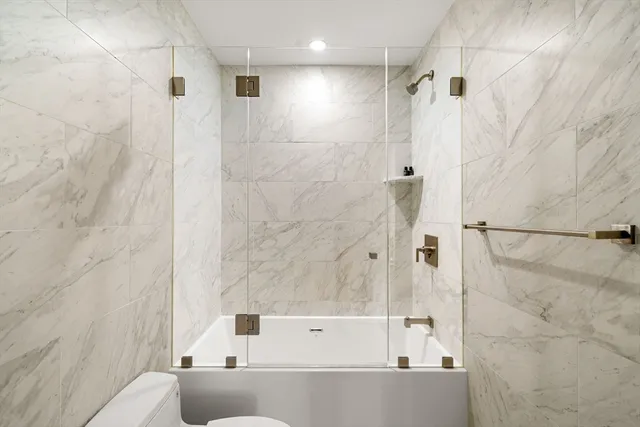 a bathroom with a bathtub and a shower