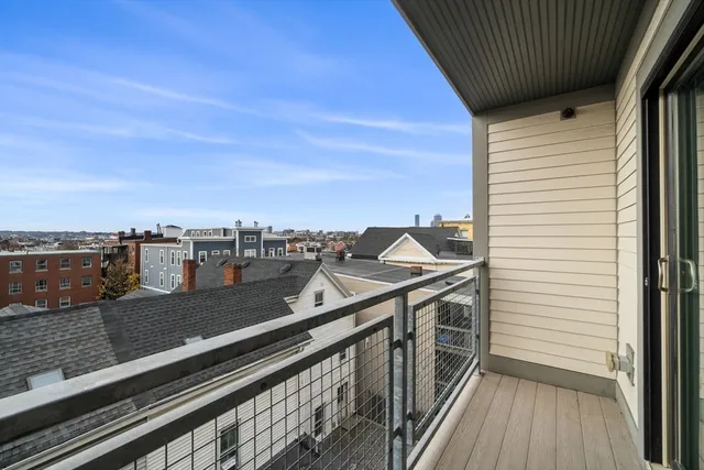 a view of a balcony with wooden floor