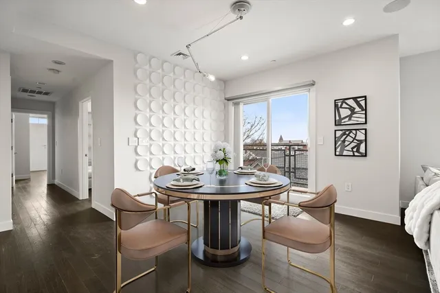 a view of a dining room with furniture and wooden floor