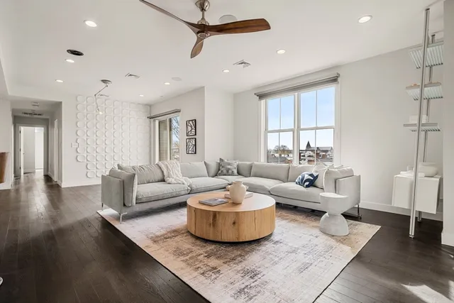 a living room with couches and a coffee table with wooden floor