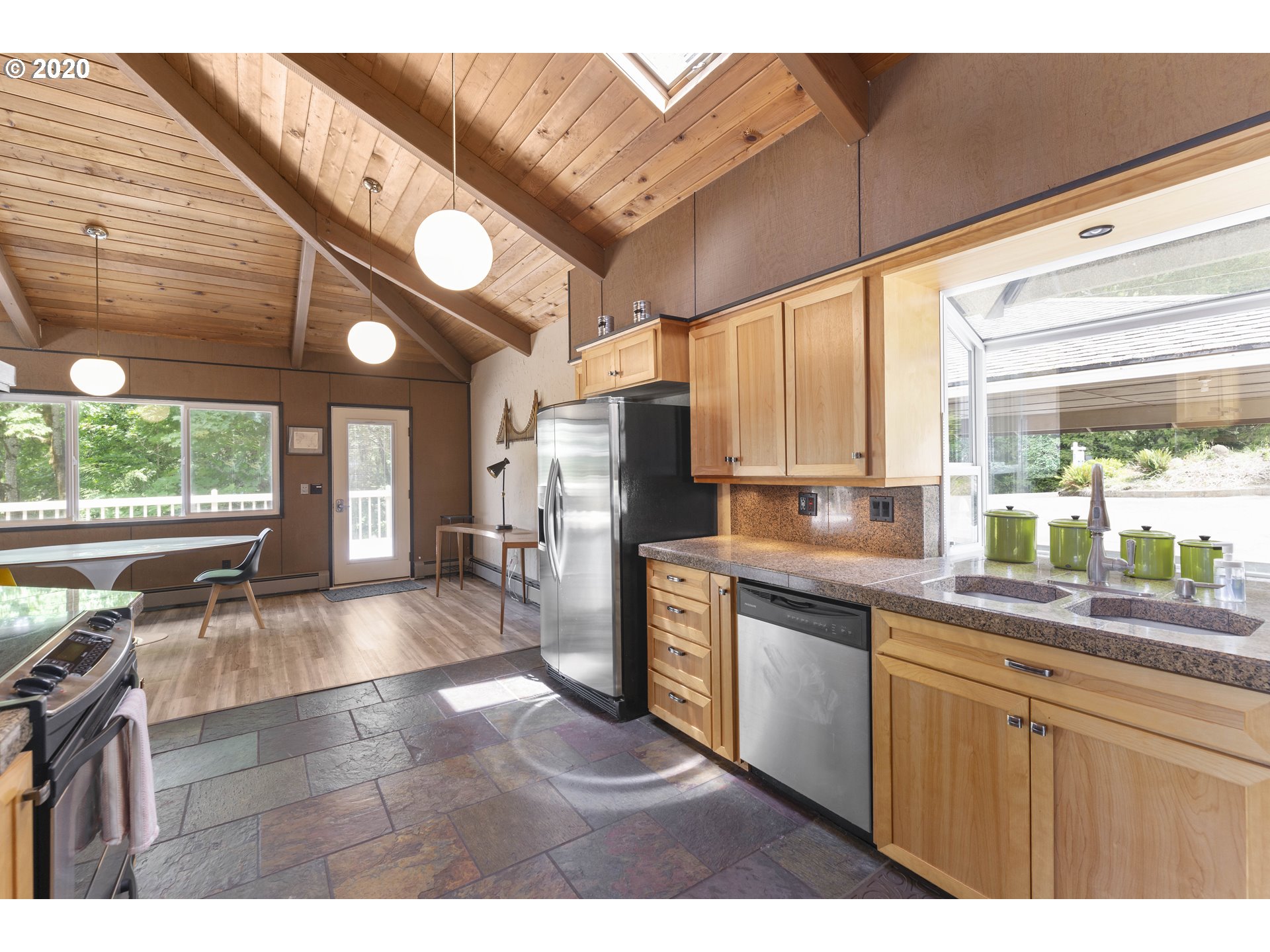16245 Northwest McNamee Road Portland, OR 97231 - Photo 5 of 32 a kitchen with stainless steel appliances granite countertop a refrigerator a sink dishwasher a stove and white countertops with wooden floor