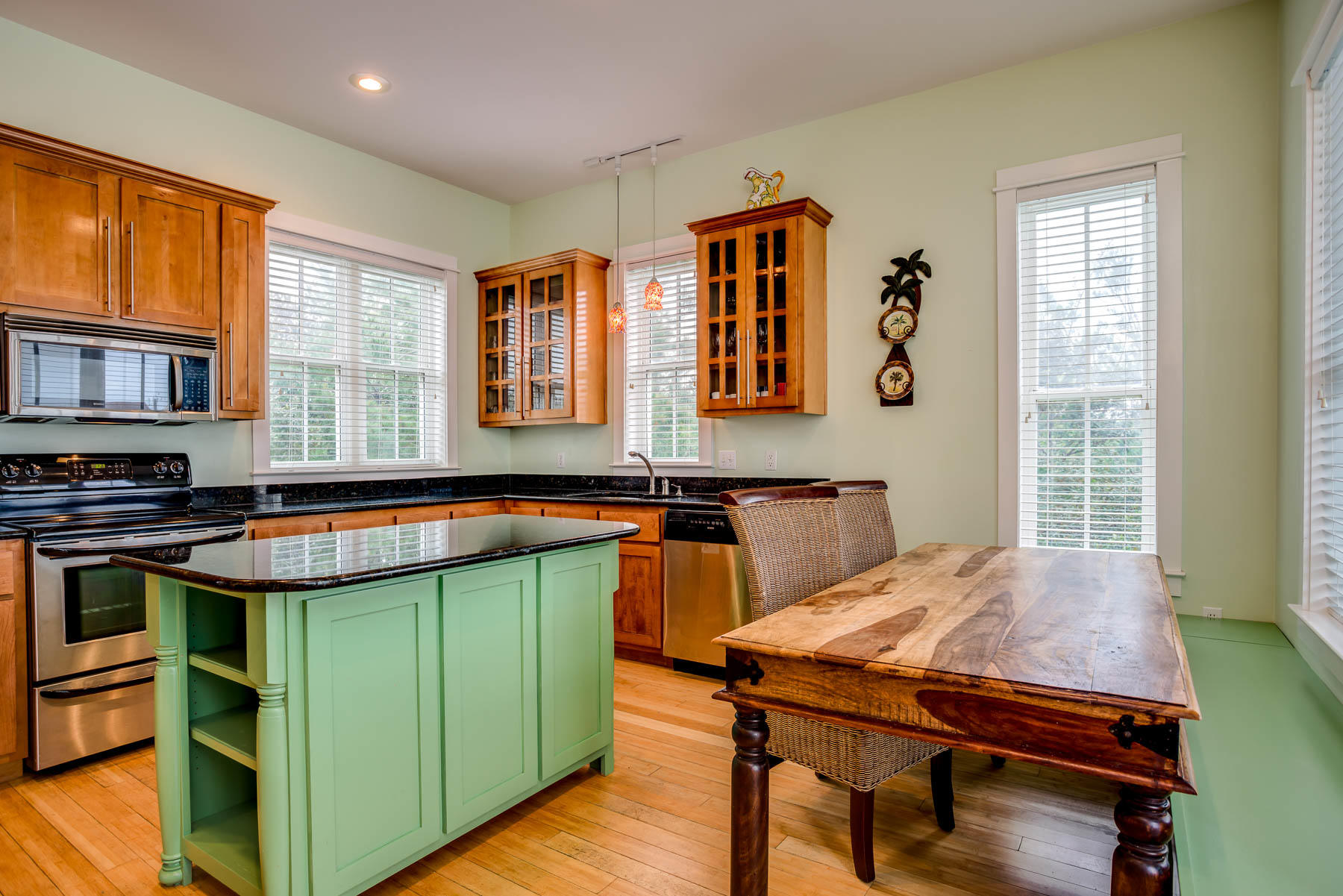 96 Chelsea Loop Road Santa Rosa Beach, FL 32459 - Photo 12 of 26 a kitchen with a kitchen island a stove a sink dishwasher and cabinets with wooden floor