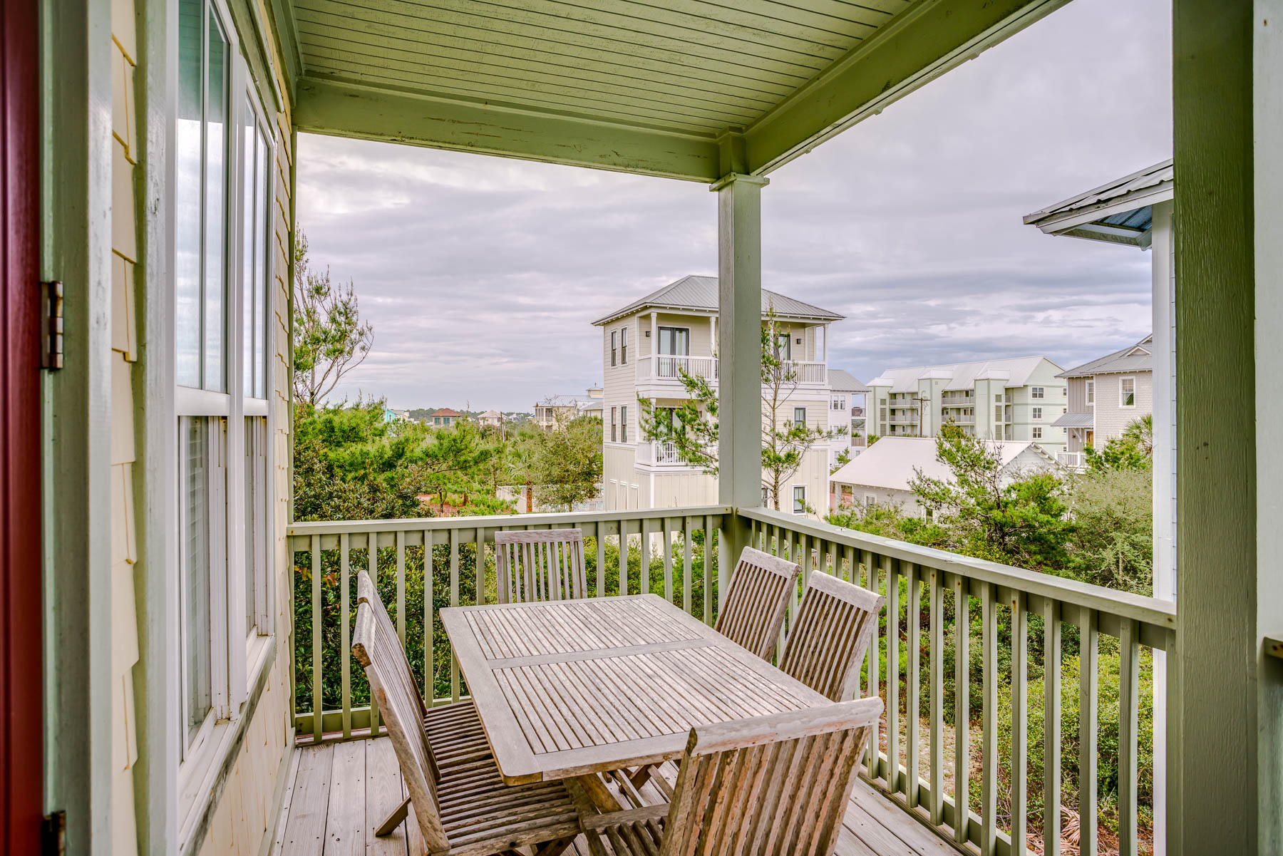 96 Chelsea Loop Road Santa Rosa Beach, FL 32459 - Photo 14 of 26 a view of a balcony with a table and chairs