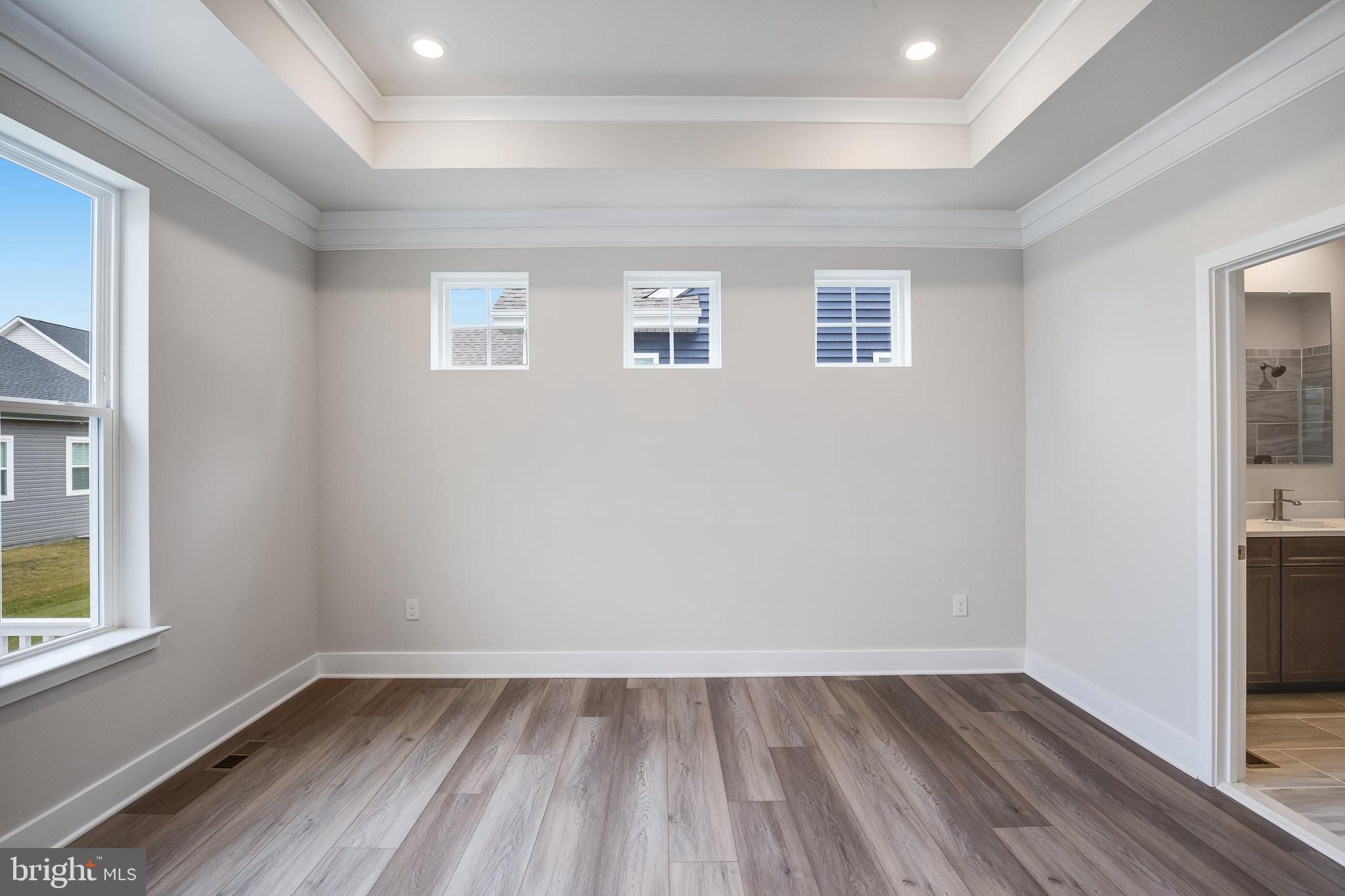203 Mariners Circle Milton, DE 19968 - Photo 11 of 32 a view of an empty room with wooden floor and a window
