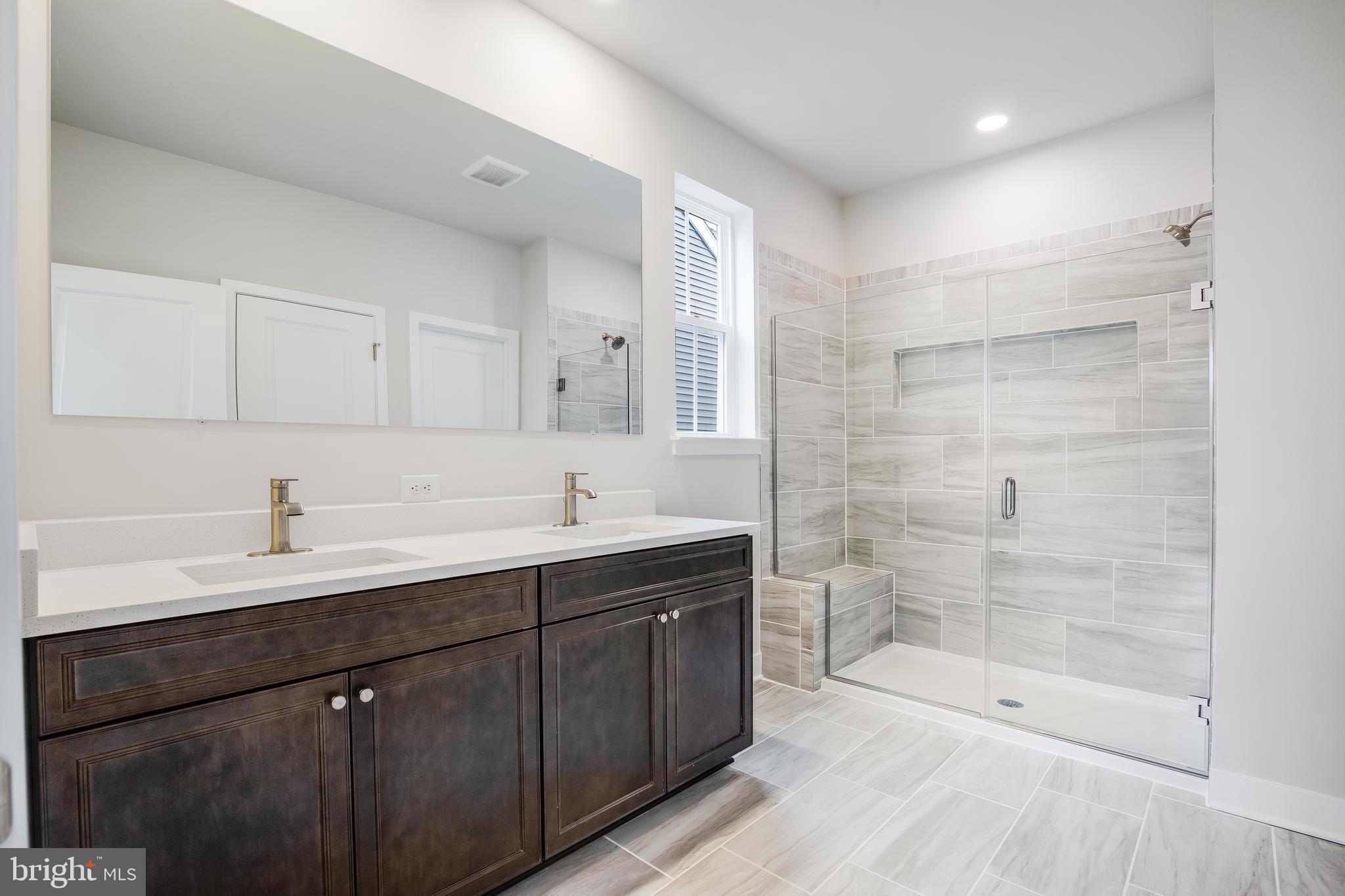 203 Mariners Circle Milton, DE 19968 - Photo 12 of 32 a bathroom with a double vanity sink mirror and shower