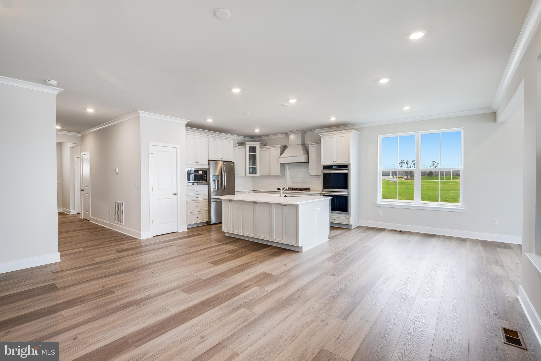 203 Mariners Circle Milton, DE 19968 - Photo 19 of 32 a view of kitchen with wooden floor and electronic appliances