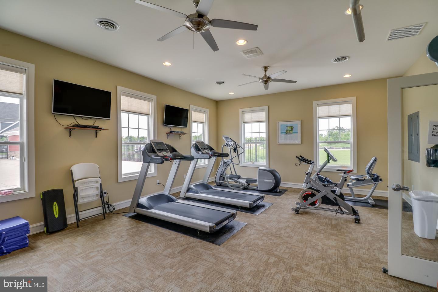 203 Mariners Circle Milton, DE 19968 - Photo 25 of 32 a room with gym equipment and a flat screen tv