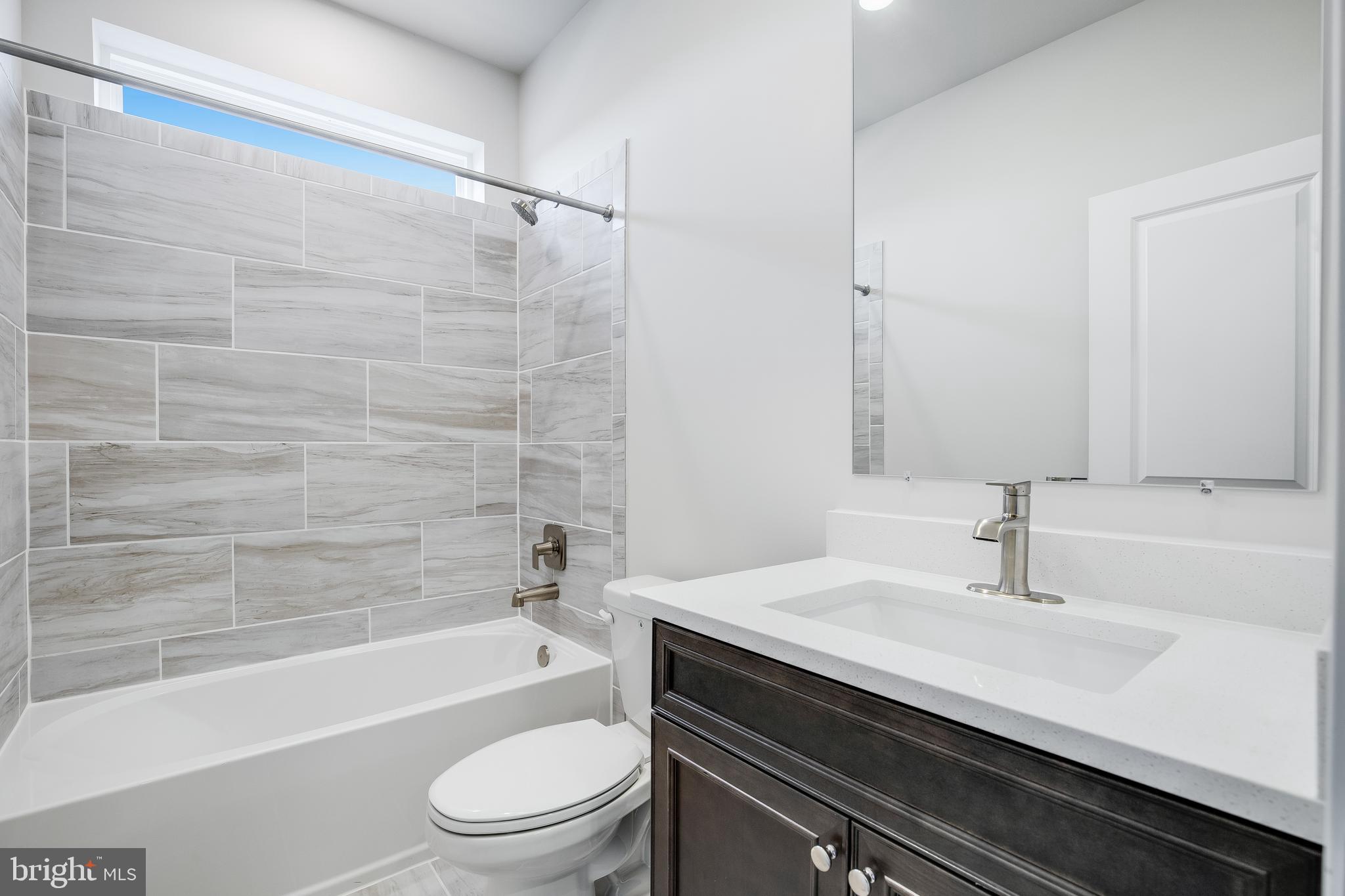 203 Mariners Circle Milton, DE 19968 - Photo 4 of 32 a bathroom with a sink a toilet and a bathtub