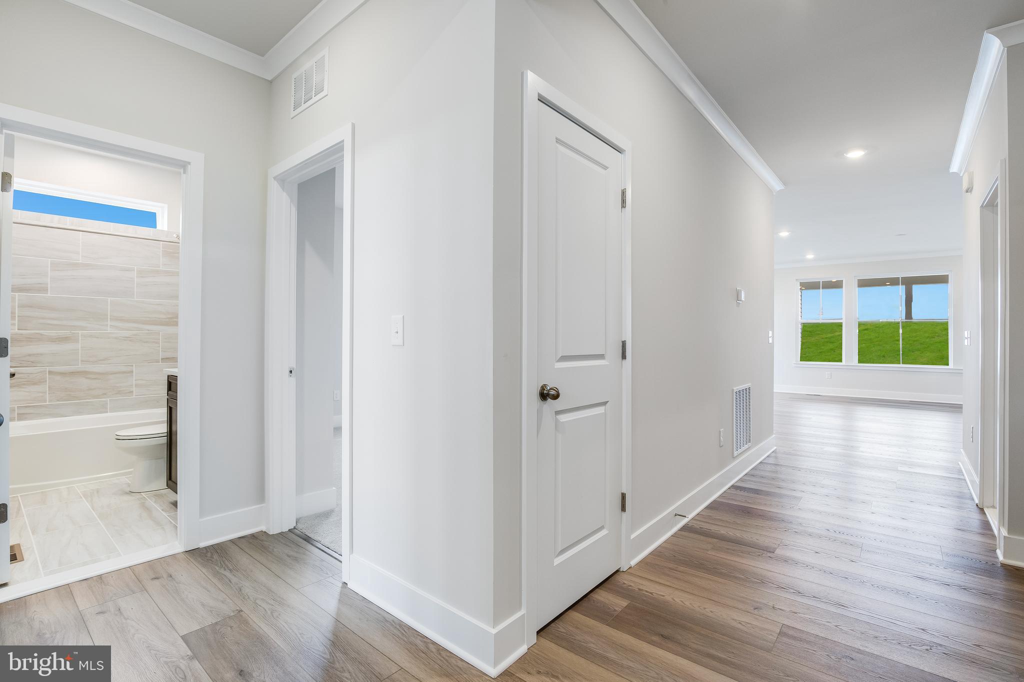 203 Mariners Circle Milton, DE 19968 - Photo 7 of 32 a view of an entryway with wooden floor and windows