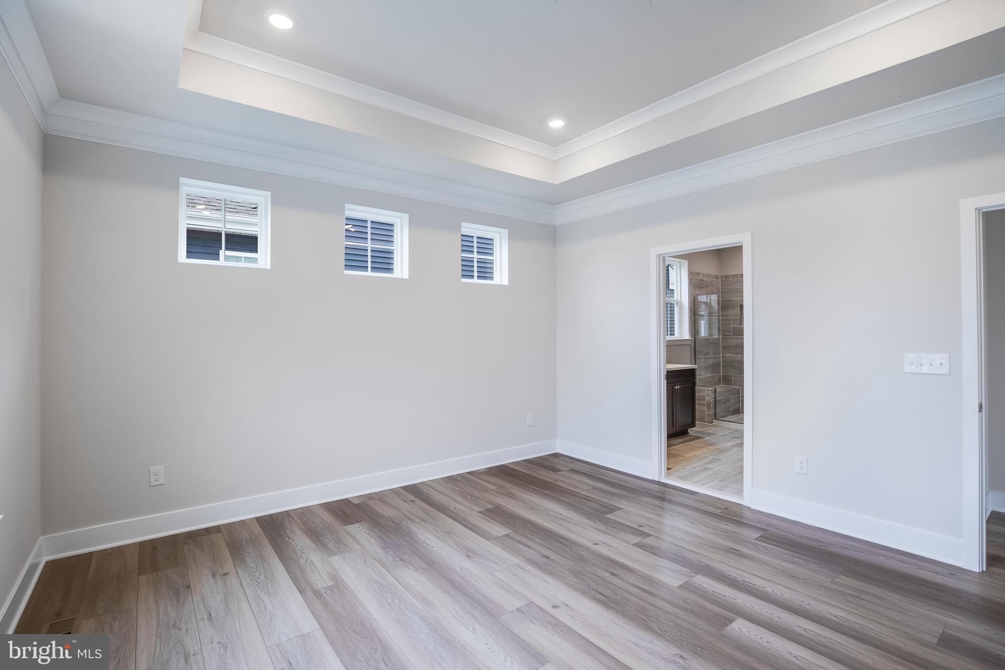 203 Mariners Circle Milton, DE 19968 - Photo 10 of 32 a view of an empty room with wooden floor and a window
