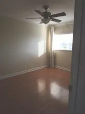 a view of a room with wooden floor