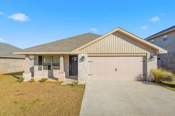 a front view of a house with yard and seating space