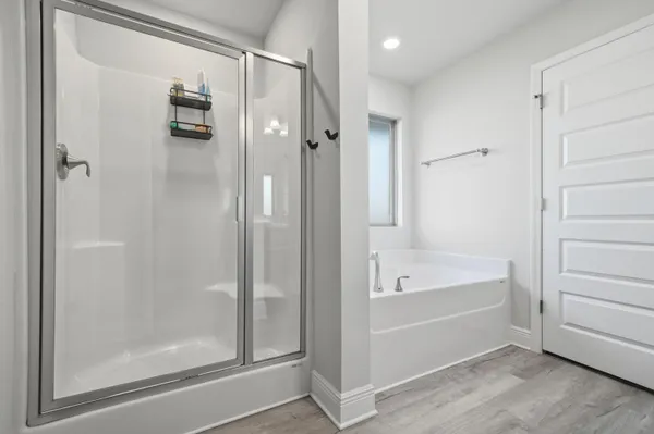 a bathroom with a tub shower and sink