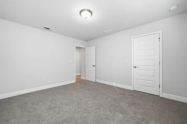 an empty room with closet area