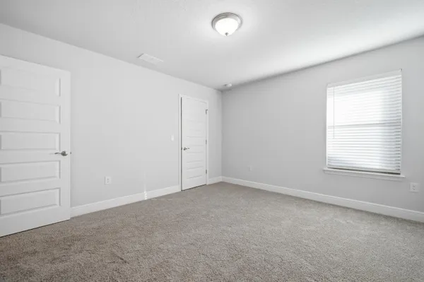 an empty room with a empty space and windows