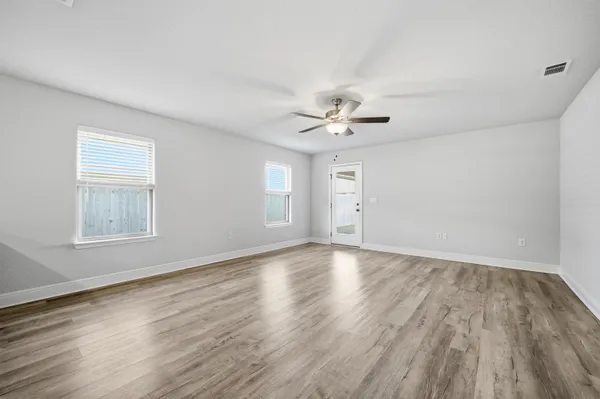 wooden floor in an empty room with a window