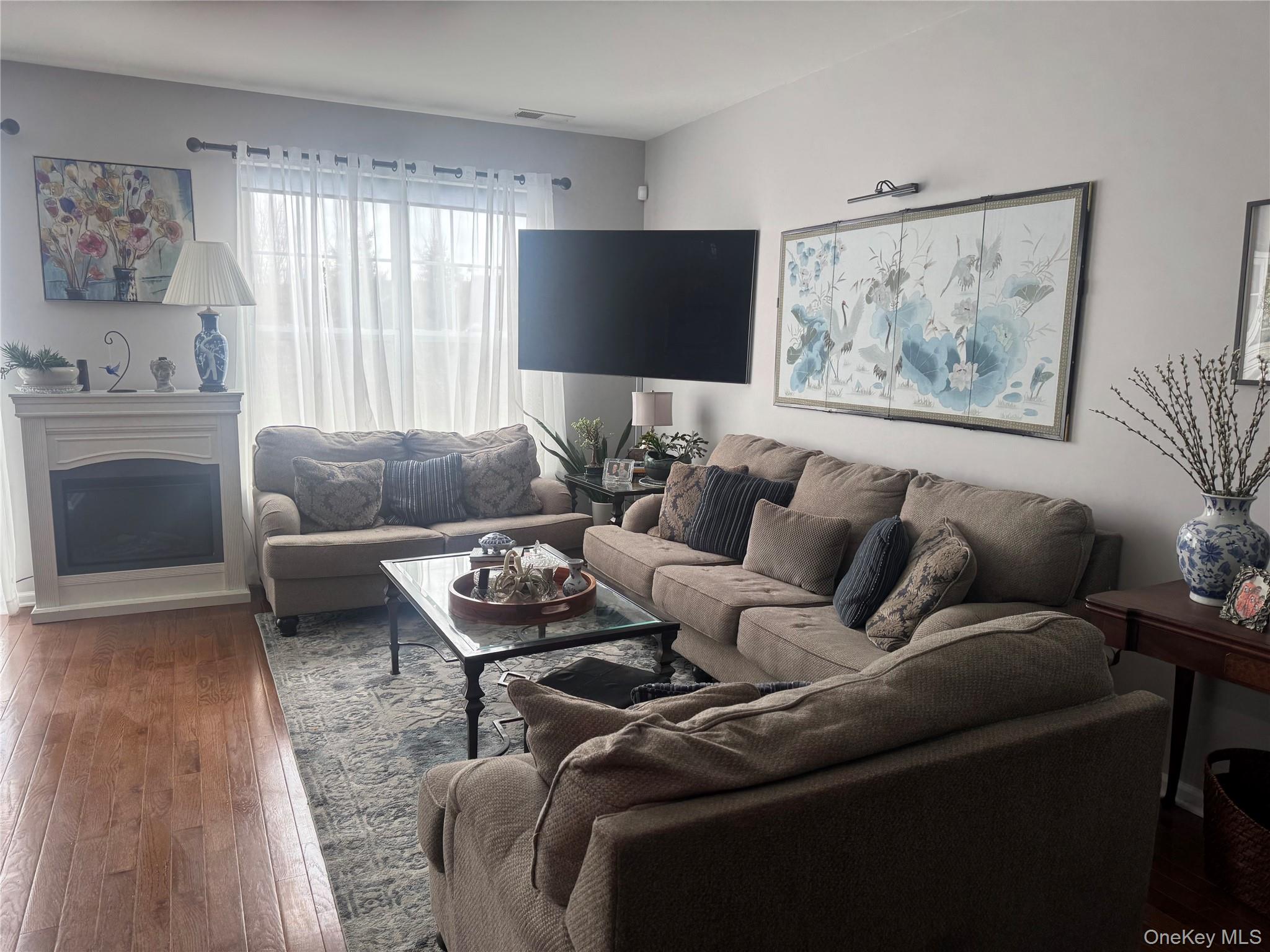 21 High Ridge Lane, Unit 21 Middletown, NY 10940 - Photo 13 of 33 a living room with furniture and a flat screen tv