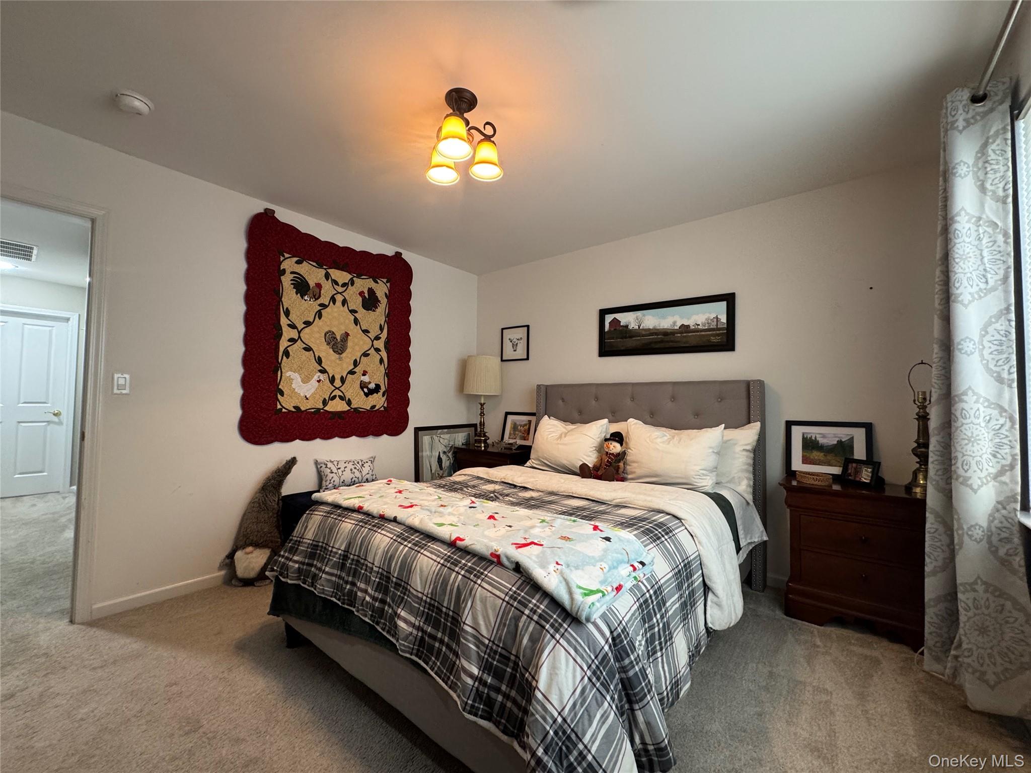 21 High Ridge Lane, Unit 21 Middletown, NY 10940 - Photo 18 of 33 a bedroom with a bed and a painting on the wall