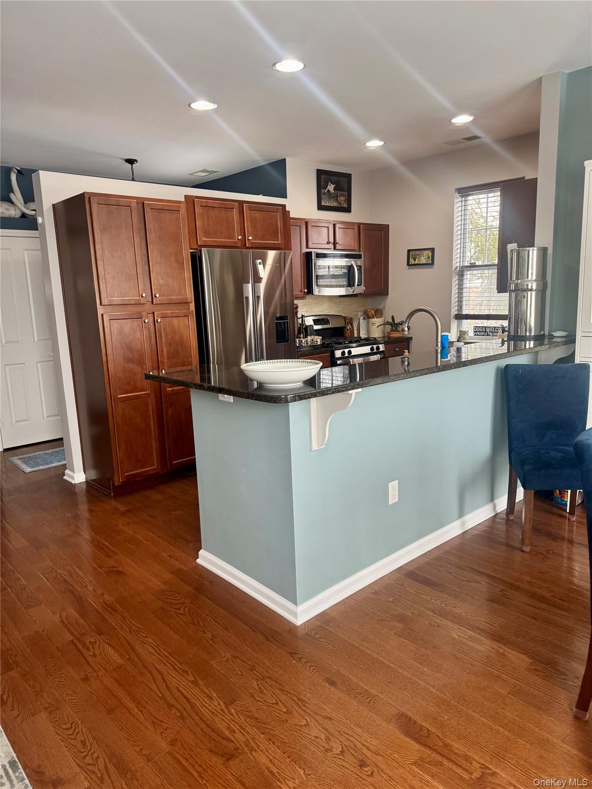21 High Ridge Lane, Unit 21 Middletown, NY 10940 - Photo 8 of 33 a kitchen with stainless steel appliances a refrigerator a stove a sink a microwave a dining table and chairs