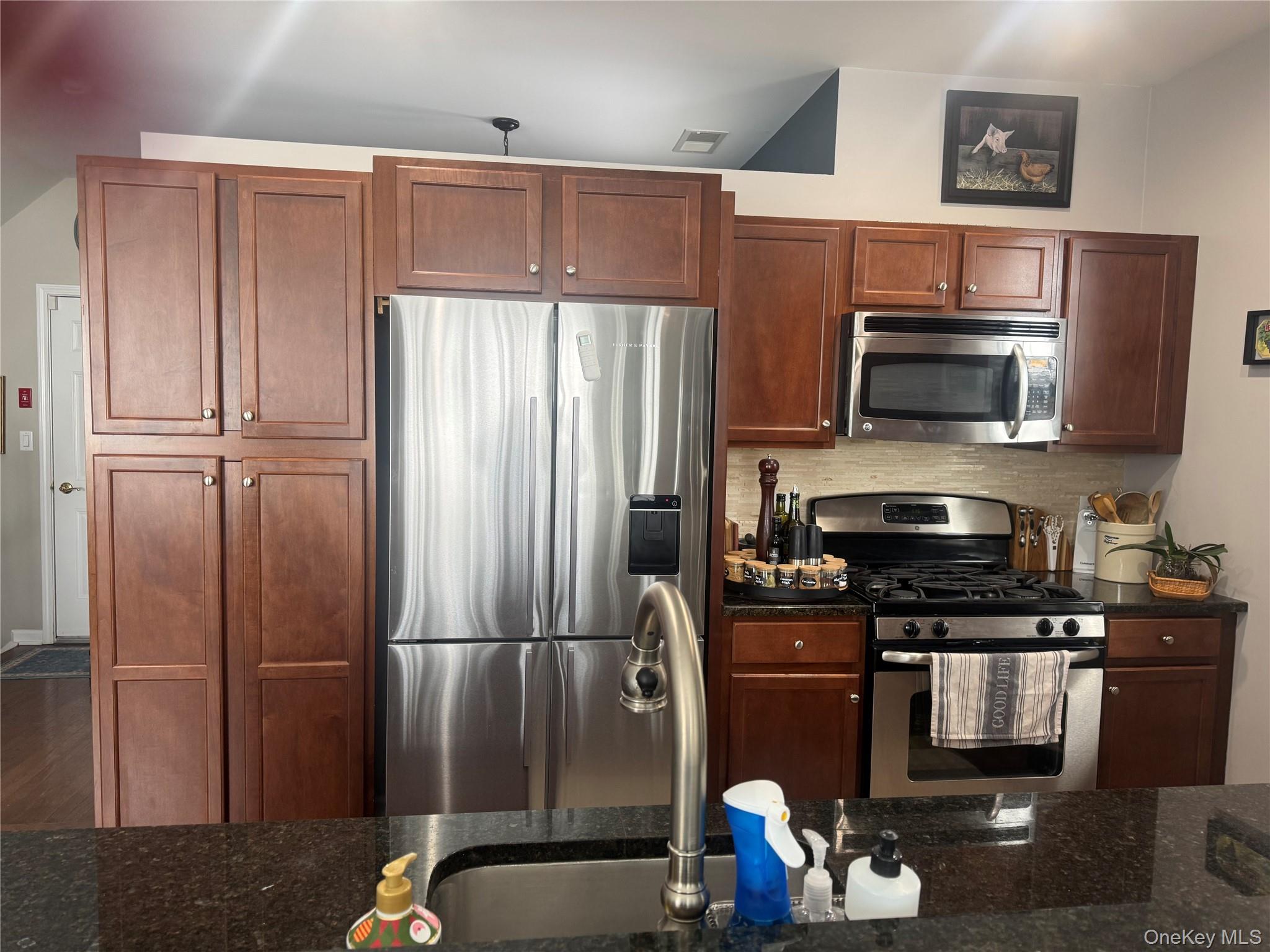 21 High Ridge Lane, Unit 21 Middletown, NY 10940 - Photo 9 of 33 a kitchen with a refrigerator and a stove top oven