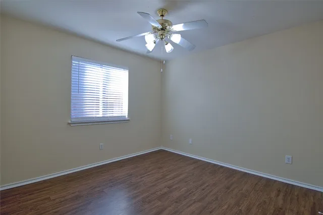 a view of a room with a window and wooden floor