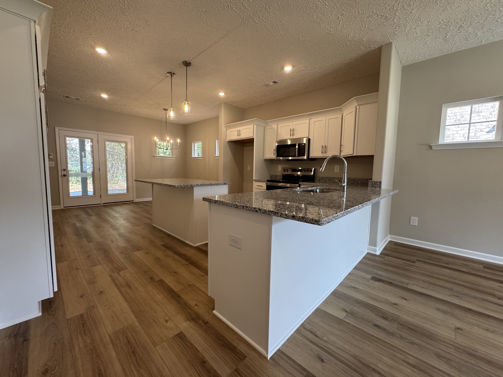57 Laurel View Street Manchester, TN 37355 - Photo 6 of 23 a kitchen with stainless steel appliances granite countertop a refrigerator a stove and a wooden floors
