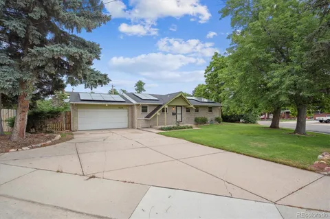 a front view of house with yard and trees