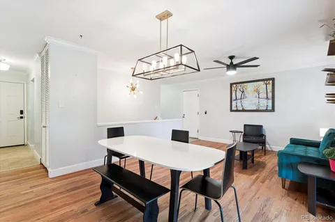 a view of a dining room with furniture wooden floor and chandelier