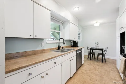 a kitchen with sink and cabinets