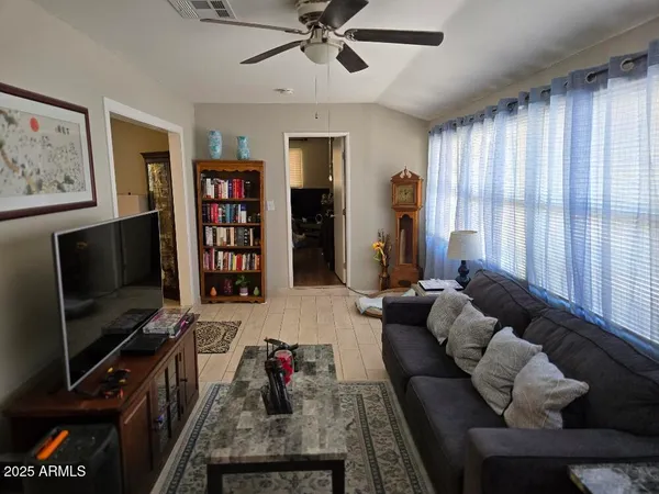 a living room with furniture and a flat screen tv